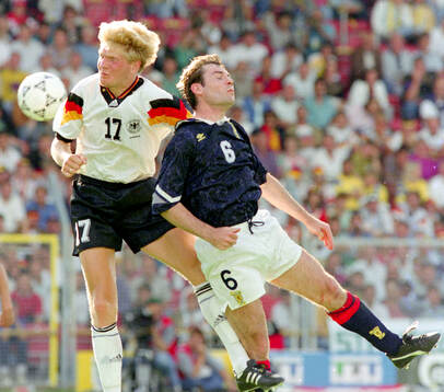Germanys Stefan Effenberg (L) against Scotlands Brian