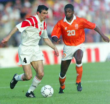 Ahkrik Tsveiba of CIS (L) against Netherlands Bryan Roy