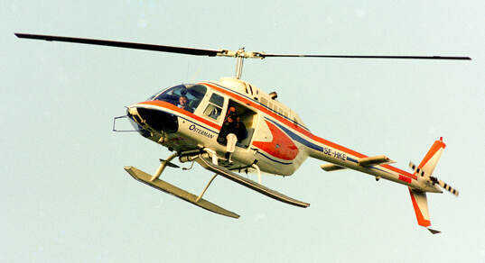 A helicopter with a photographer hovering over Nya Ullevi