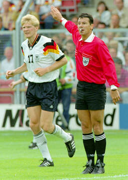 Referee Guy Goethals, left Germanys Stefan Effenberg