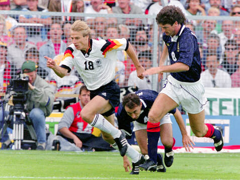 Germanys Jurgen Klinsmann against Scotlands Dave McPherson