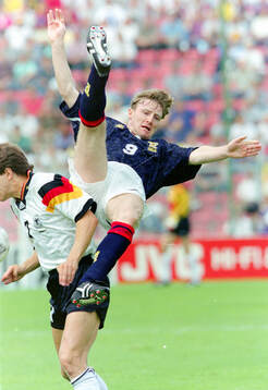 Scotlands Stewart McKimmie against Germanys Andreas Möller