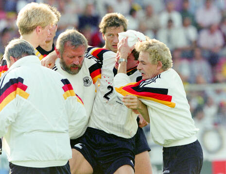 Germanys Stefan Reuter is carried off the pitch