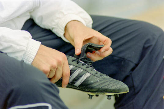 A german player checks his adidas football boot