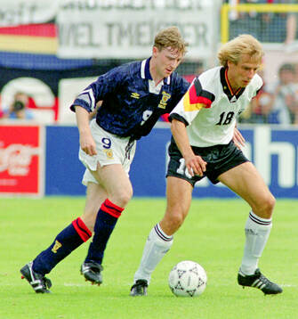 Germanys Jurgen Klinsmann against Scotlands Stewart McKimmie