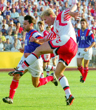 Denmarks Henrik Larsen shoots to score his 1-0 goal