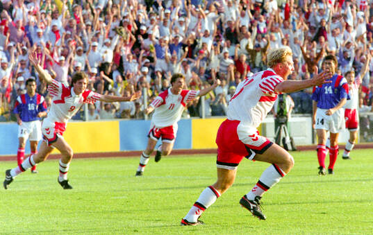 Denmarks Henrik Larsen celebrates his 1-0 goal