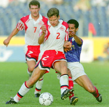 Denmarks John Sivebaek against France‚Äôs Pascal Vahirua