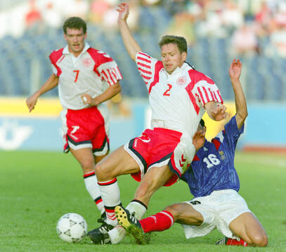 Denmarks John Sivebaek against France‚Äôs Pascal Vahirua