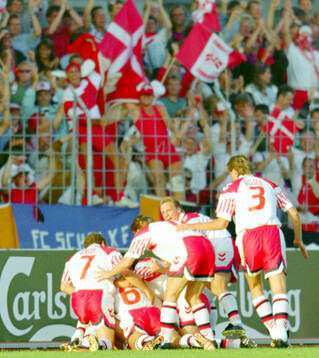 Denmarks players celebrates Lars Elstrups winning 2-1 goal