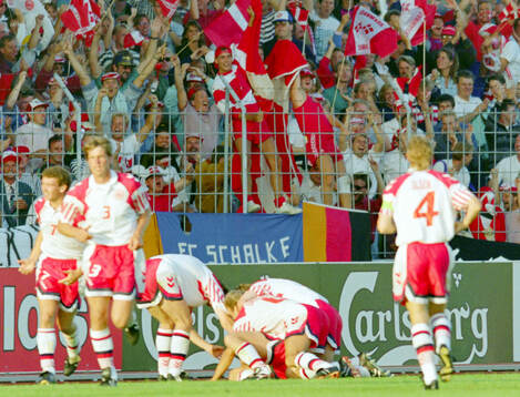 Denmarks players celebrates Lars Elstrups winning 2-1 goal