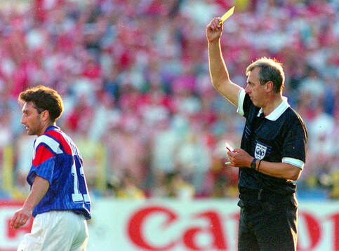Referee Hubert Forstinger shows a yellow card for Christian