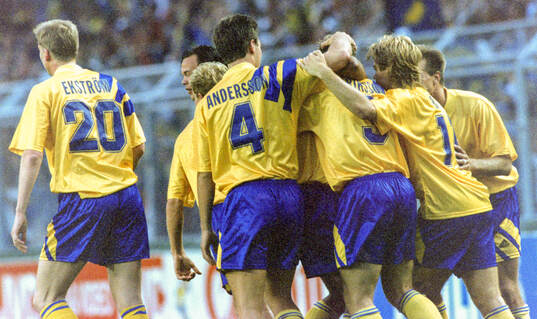 Swedens Jan Eriksson (# 3 centre) celebrates his equalizing