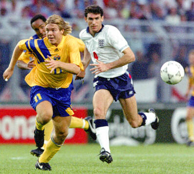 Swedens Tomas Brolin is chased by Englands Martin Keown