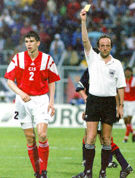 Referee Kurt Rothlisberger shows Andrey Chernyshov of CIS a