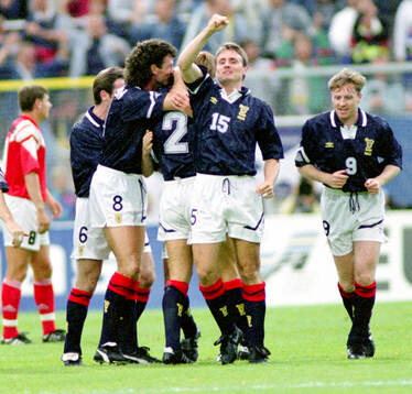 Scotlands Paul McStay (not visible) celebrates his 1-0 goal
