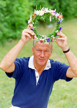 Swedens manager Tommy Svensson with a midsummer wreath at