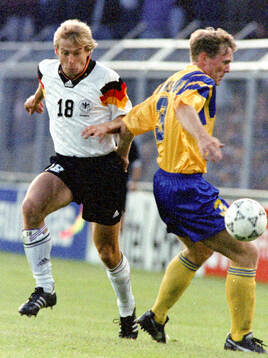 Jurgen Klinsmann of Germany against Jan Eriksson of Sweden