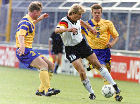 Jurgen Klinsmann of Germany against Jan Eriksson (L) and
