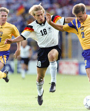 Jurgen Klinsmann of Germany against Jan Eriksson (L) and