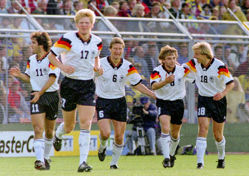 Germanys Thomas Hassler (2nd R) celebrates his 1-0 goal