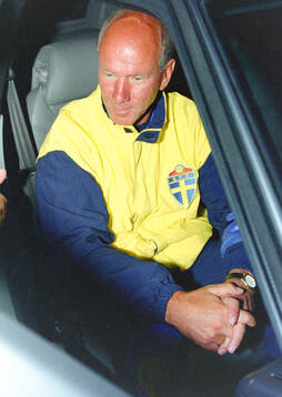 Swedens manager Tommy Svensson talks to the press sitting