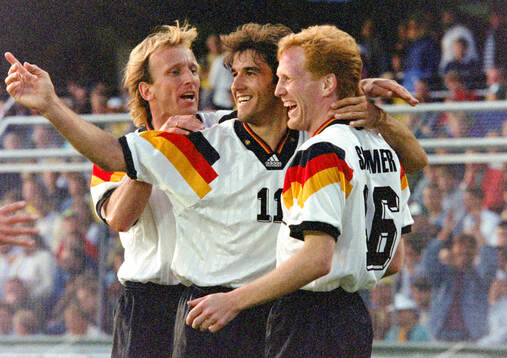 Germanys Karl-Heinz Riedle (C) celebrates his 2-0 goal with
