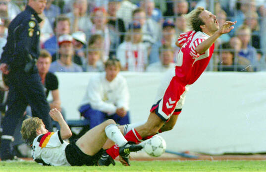 Denmarks Kim Christofte is tackled by Germanys Thomas