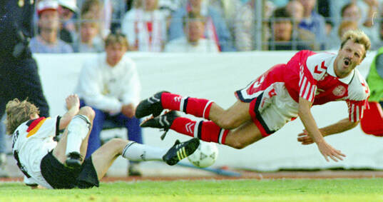 Denmarks Kim Christofte is tackled by Germanys Thomas
