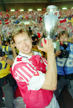 Denmarks John Sivebaek celebrates with the trophy