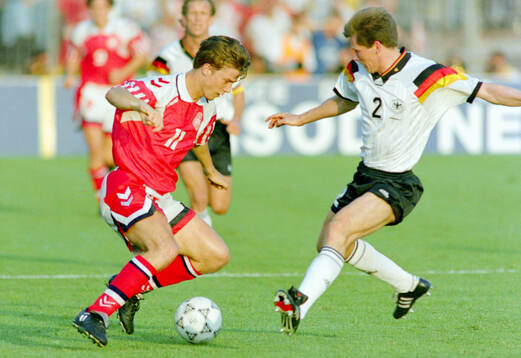Denmarks Brian Laudrup (L) against Germanys Stefan Reuter