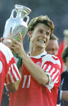 Denmarks Brian Laudrup celebrates with the trophy
