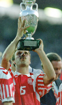 Denmarks Kim Christofte celebrates with the trophy