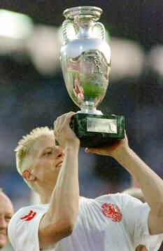 Denmarks Peter Schmeichel celebrates with the trophy