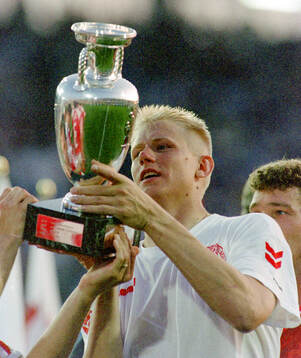 Denmarks Peter Schmeichel celebrates with the trophy