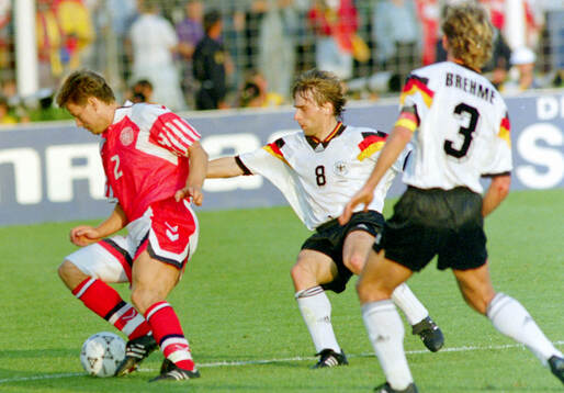 Denmarks John Sivebaek against Germanys Thomas Hassler and