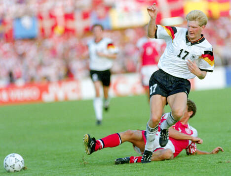 Germanys Stefan Effenberg is tackled by Denmarks John Jensen
