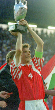 Denmarks captain Lars Olsen celebrates with the trophy