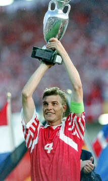 Denmarks captain Lars Olsen celebrates with the trophy