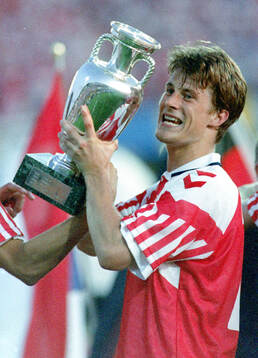 Denmarks Brian Laudrup celebrates with the trophy