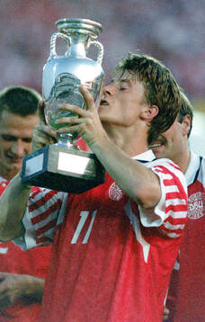 Denmarks Brian Laudrup celebrates with the trophy
