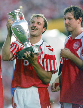 Denmarks BKim Christofte celebrates with the trophy