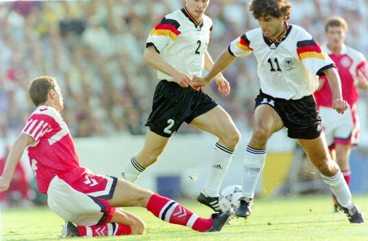 Germanys Karl-Heinz Riedle (R) against Denmarks Torben