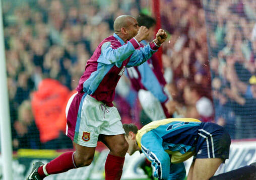 Trevor Sinclair of West Ham celebrates his goal behind