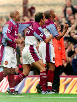 Ian Wright (R) of West Ham celebrates his goal with Trevor