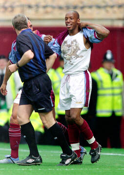 Ian Wright of West Ham celebrates his goal by pulling up