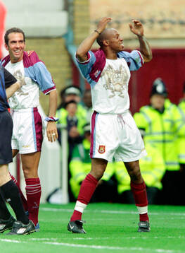 Ian Wright (R) of West Ham celebrates his goal by pulling