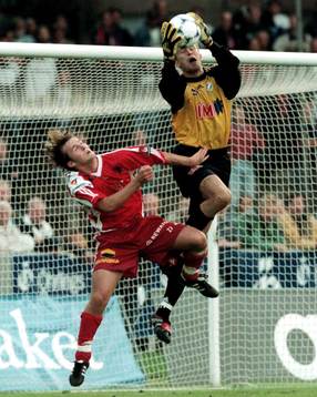 Håkan Svensson plockar ner bollen framför Jonas Nilsson